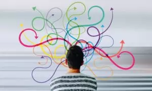 multitasking man looking at different colored arrows